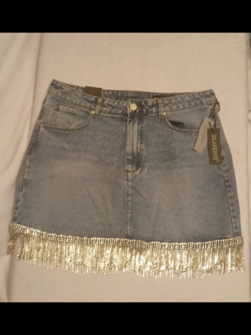 BLANKNYC denim mini skirt featuring distinct rhinestone fringe along the bottom